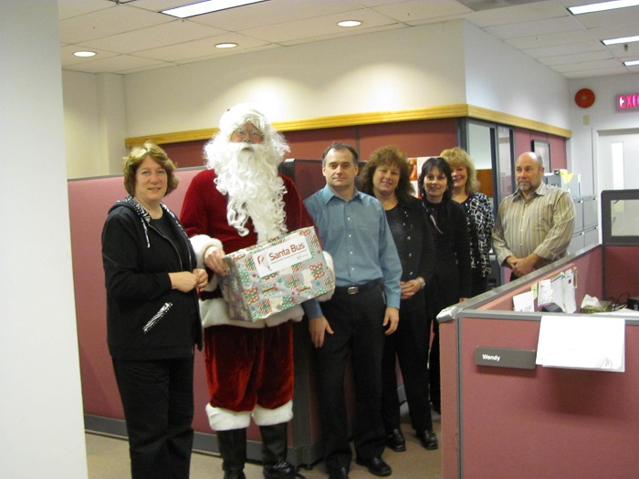 Santa with a group of city employees in an office