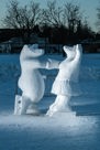A snow sculpture of two bears skating together