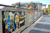 Mural on fence by baggage building