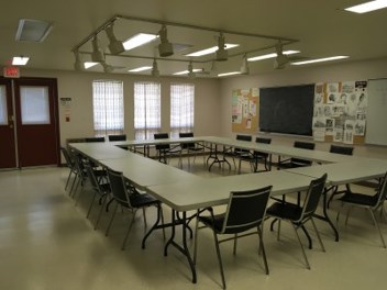 inside of the 55 Plus Centre Craft Room 1 with a square table and chairs