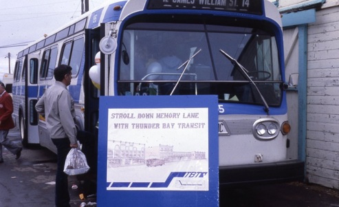 man boarding a bus that has balloons inside