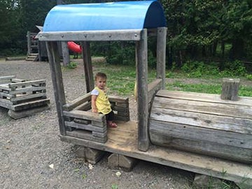 Girl on play structure at Centennial Park