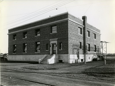 a square brick building in open grass