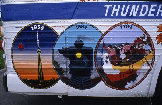 three painted circles on the side of a bus with various images