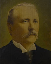 Mayor Thomas Marks sits wearing a suit and tie