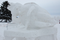 A snow sculpture of a bee with a crown