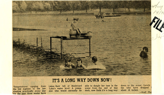 A newspaper clipping shows a photo of people swimming
