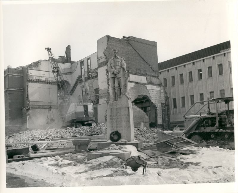city hall demolition showing a backhoe and statue