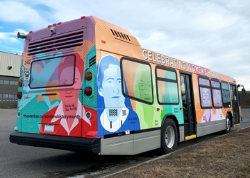 Womens History art bus, showing the back and right side of the bus with portraits of women in vibrant colours