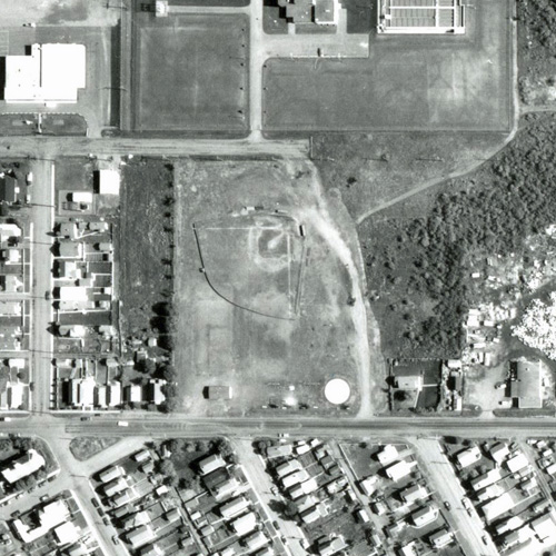 From 1974, shows a baseball diamond and some small buildings on the site