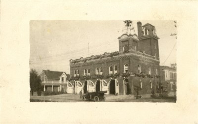 the front of a building with vehicles in front
