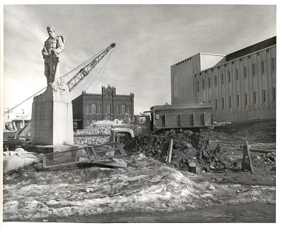 A building being demolished with construction equipment