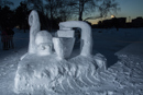 A snow sculpture of a mythical kraken creature and a ship