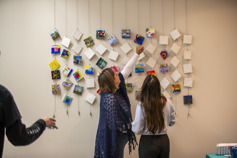 A photo of the art project with participants pointing at the art