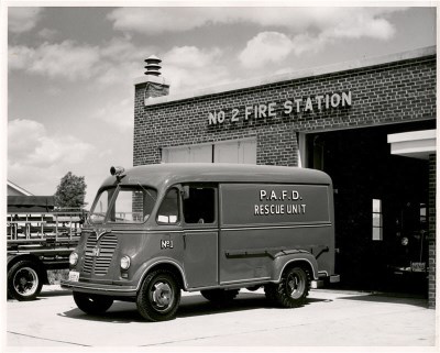 A firetruck sitting parked outside a fire station