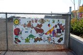 Mural on fence by baggage building