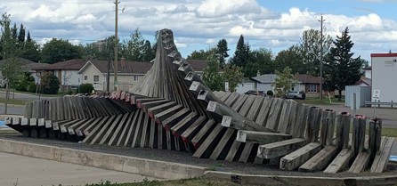 Picture of wooden sculpture with an accordion like twisting motion