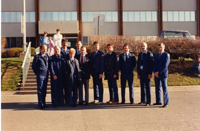 A group of people standing in front of a building