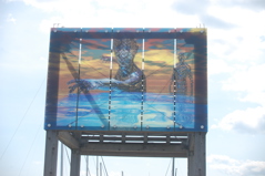 A glass pane install of the artwork Swimmers