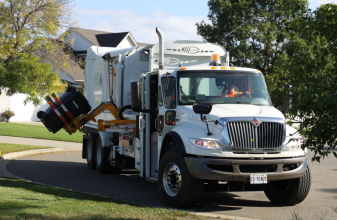 garbage packer truck lifting garbage cart