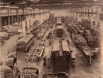 inside a plant building trolley cars. Workers are seen building models from basic to complete