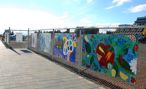 Mural on fence by baggage building