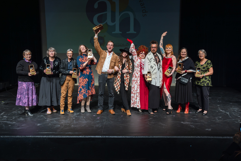 Group of award winners standing on a stage