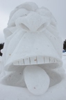 A snow sculpture of leonard cohen as a big exaggerated face