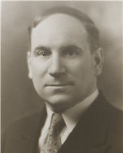 Mayor Hardiman sitting for a black and white photograph wearing a black suit