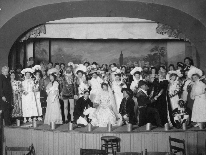 A troupe of actors dancing on stage at Port Arthur Town Hall
