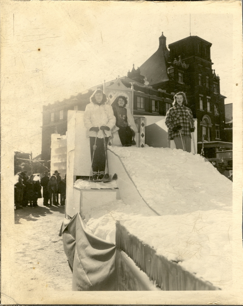 A group of children playing on a slide made of snow