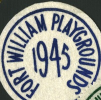 A blue and white Fort William Playground badge