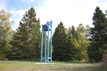 An installation of a large beach chair with a hat on the seat
