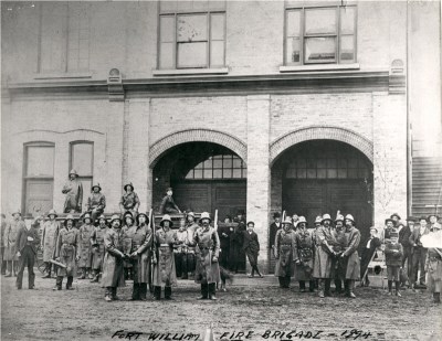 A group of firefighters standing in front of a building